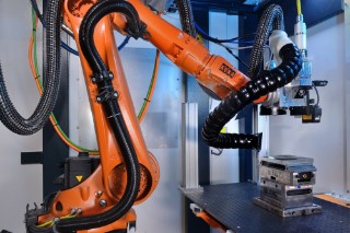 Laser structuring process with the laser processing and monitoring equipment installed in the KUKA flexibleCUBE robot cell.